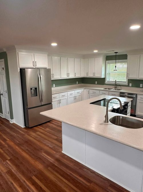 The finished kitchen with an island, a new sink and new appliances.