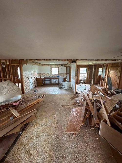 The house gutted to the studs with the old kitchen stripped out.